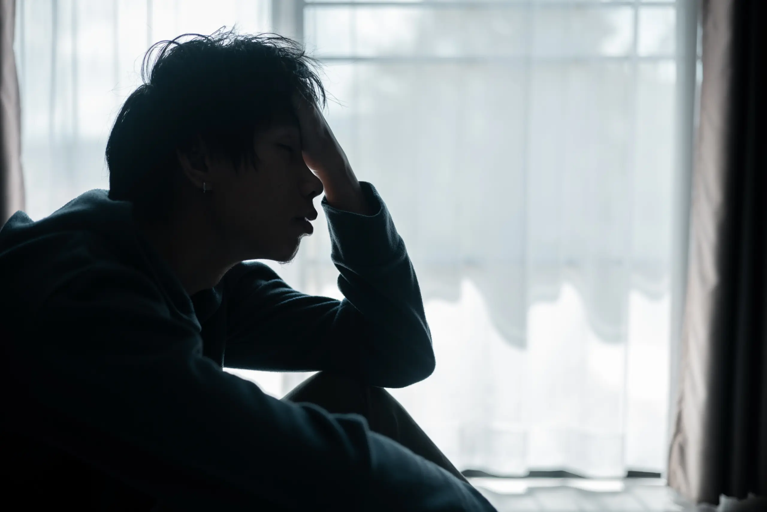 person sitting alone in contemplation, facing emotional struggles with drug use