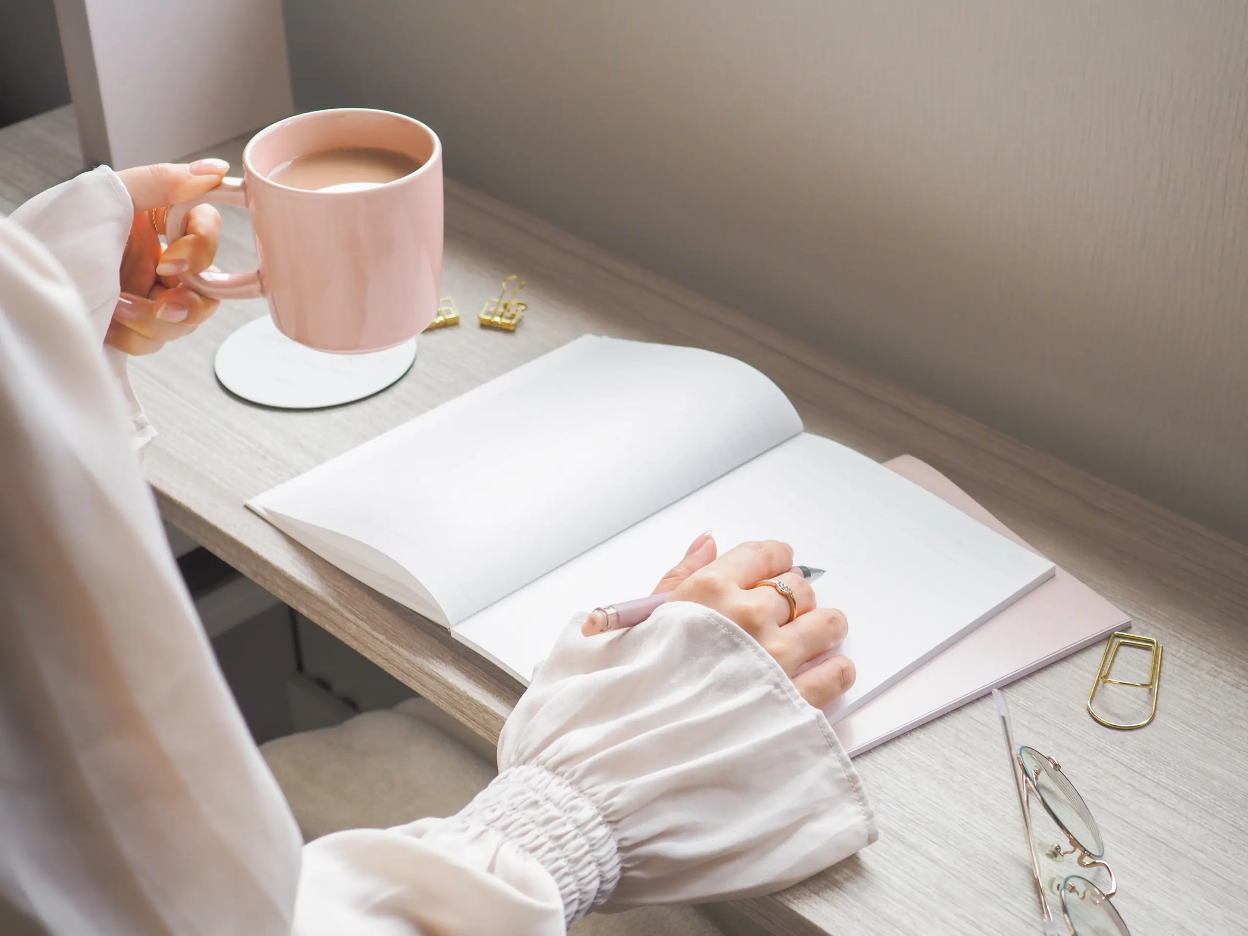 Woman journaling during a mental health check-in with natural light