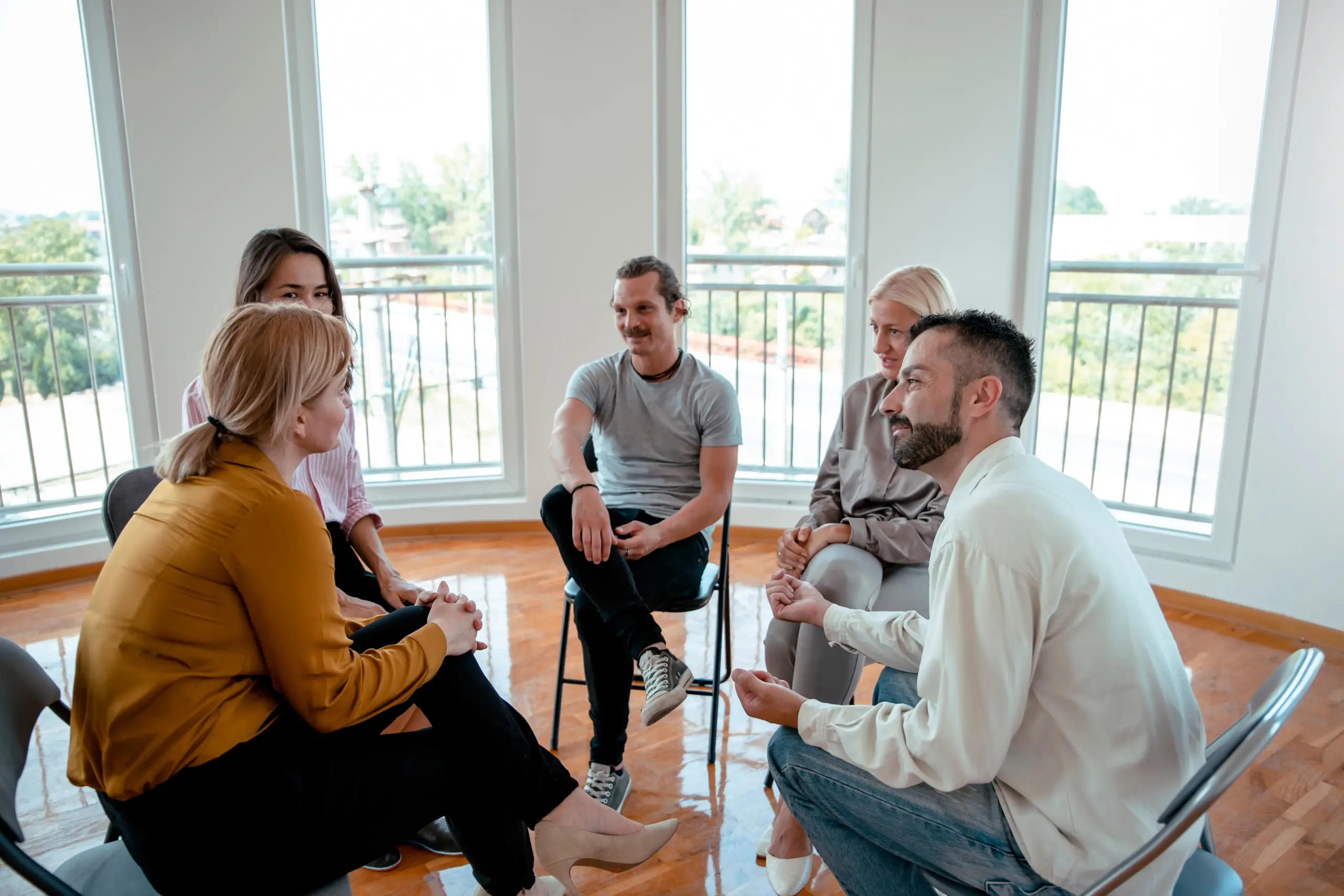 A supportive community meeting discussing long-term success rates in recovery.